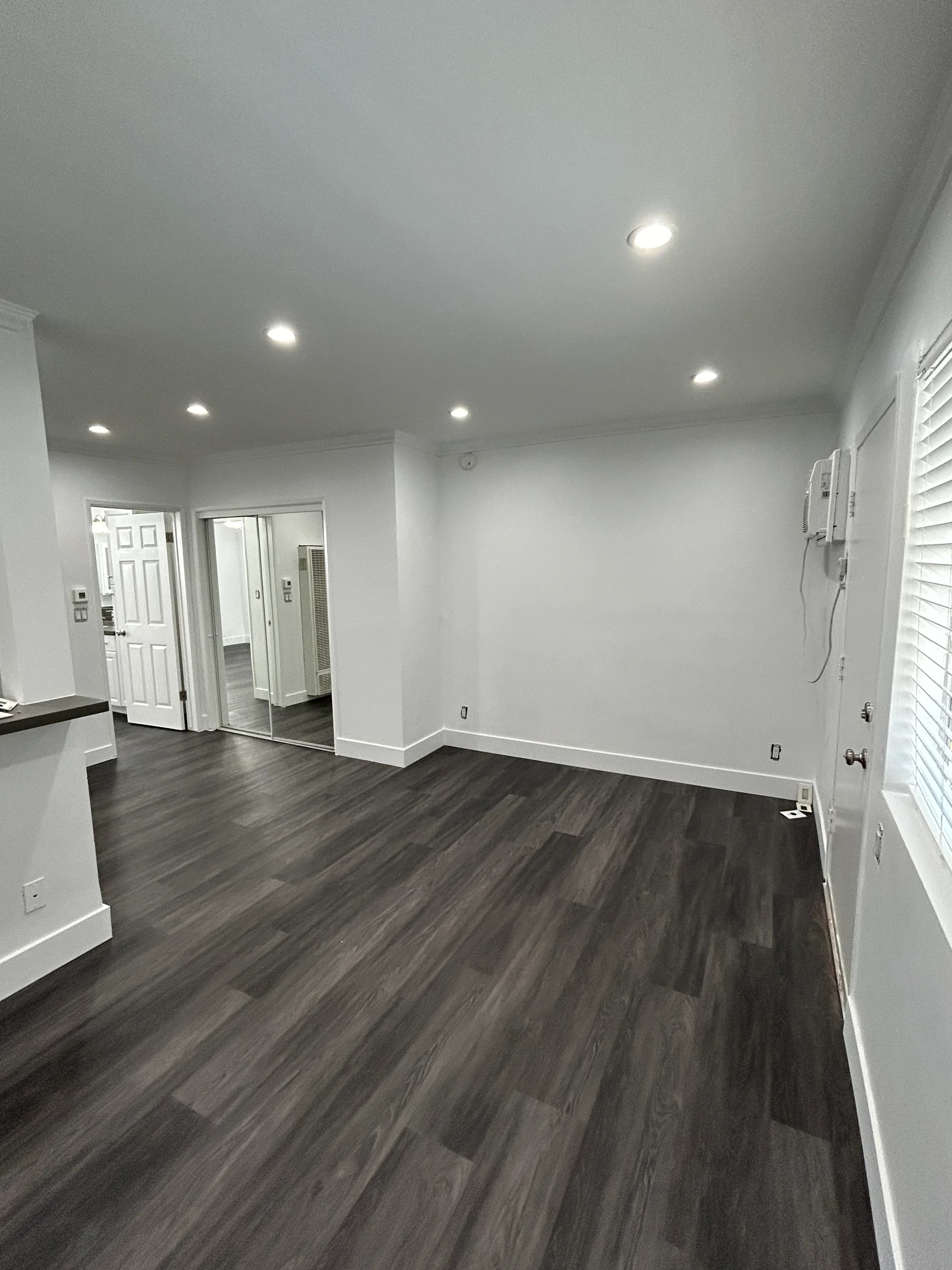 Spacious living room with hardwood flooring and recessed lighting. (photo 1 of 16)