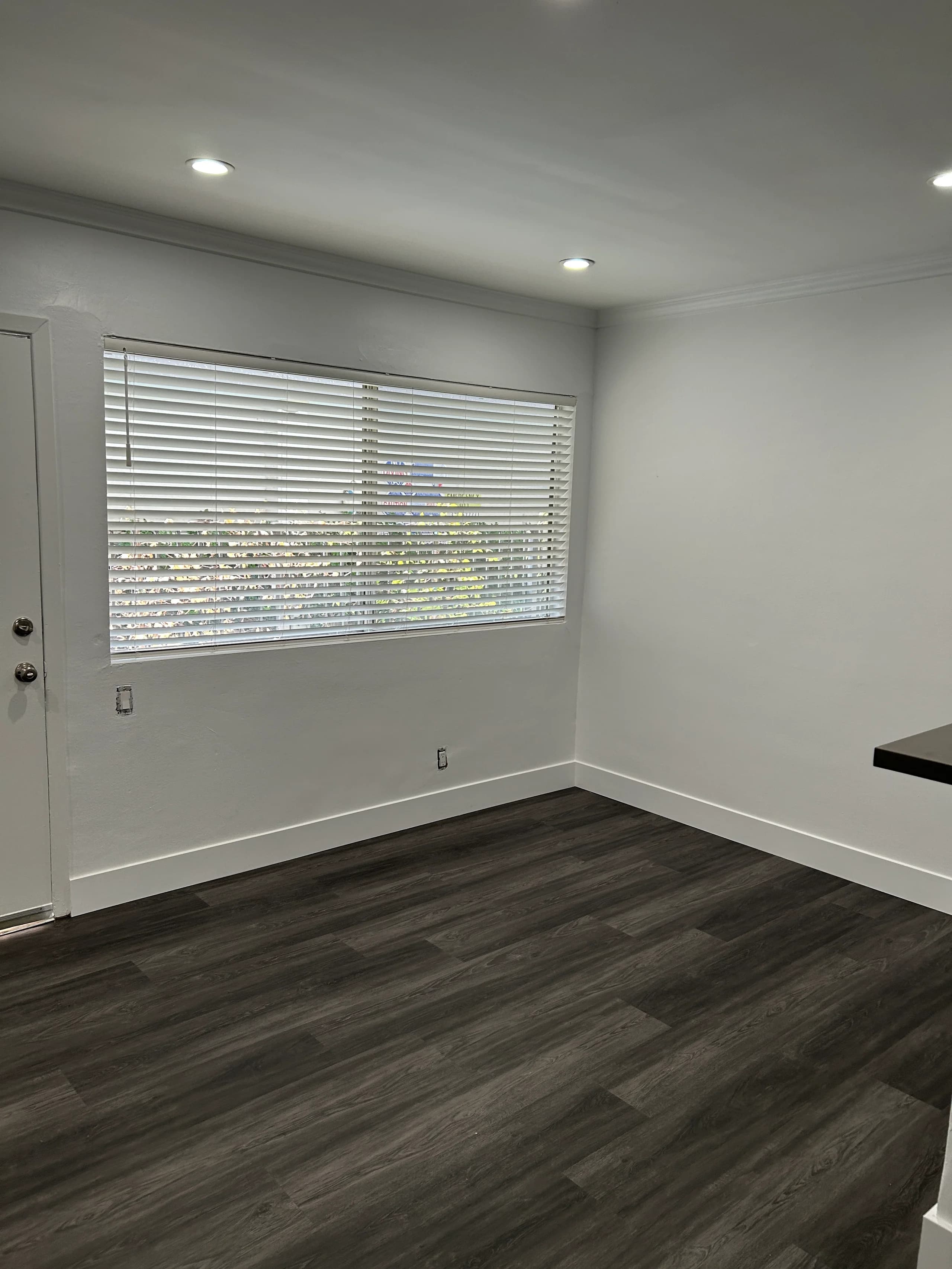 Bright living room with hardwood flooring and large windows. (photo 2 of 16)