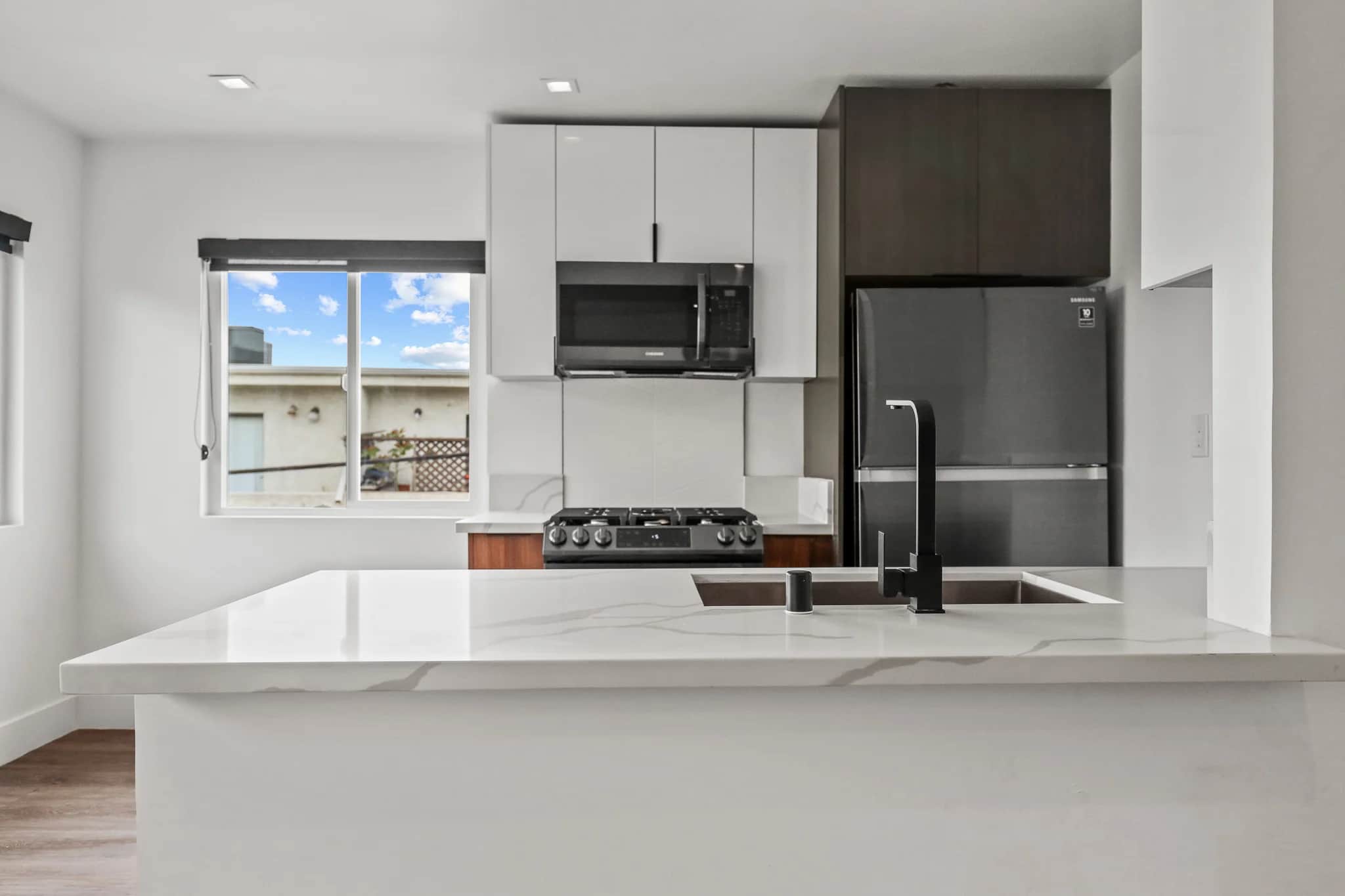 Modern kitchen with stainless steel appliances and a large granite countertop. (photo 1 of 25)