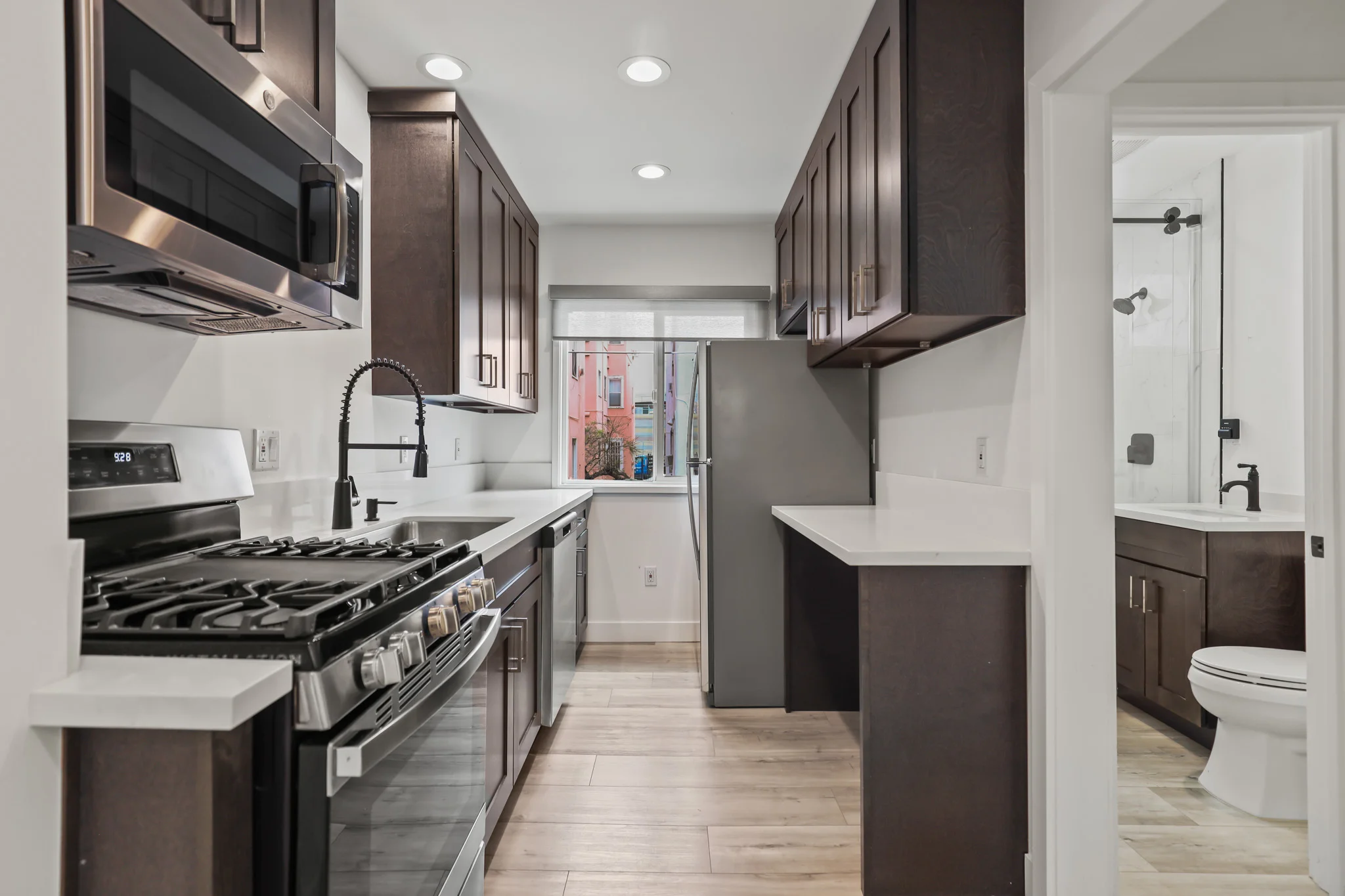Modern kitchen with stainless steel appliances and granite countertops. (photo 2 of 19)
