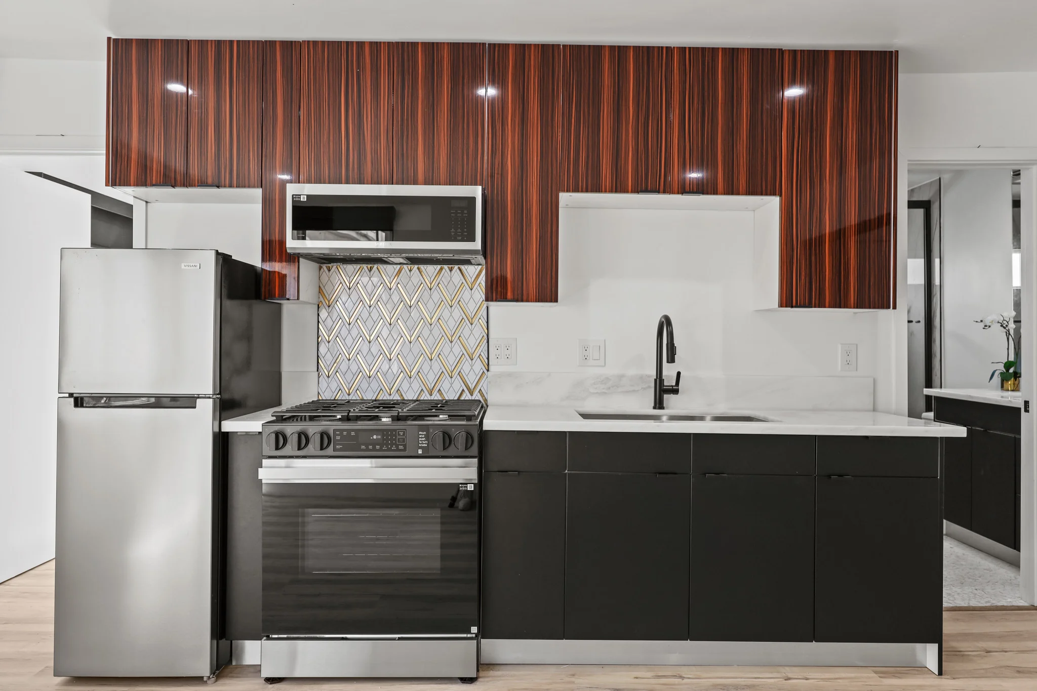 Modern kitchen featuring stainless steel appliances and sleek cabinetry. (photo 2 of 17)