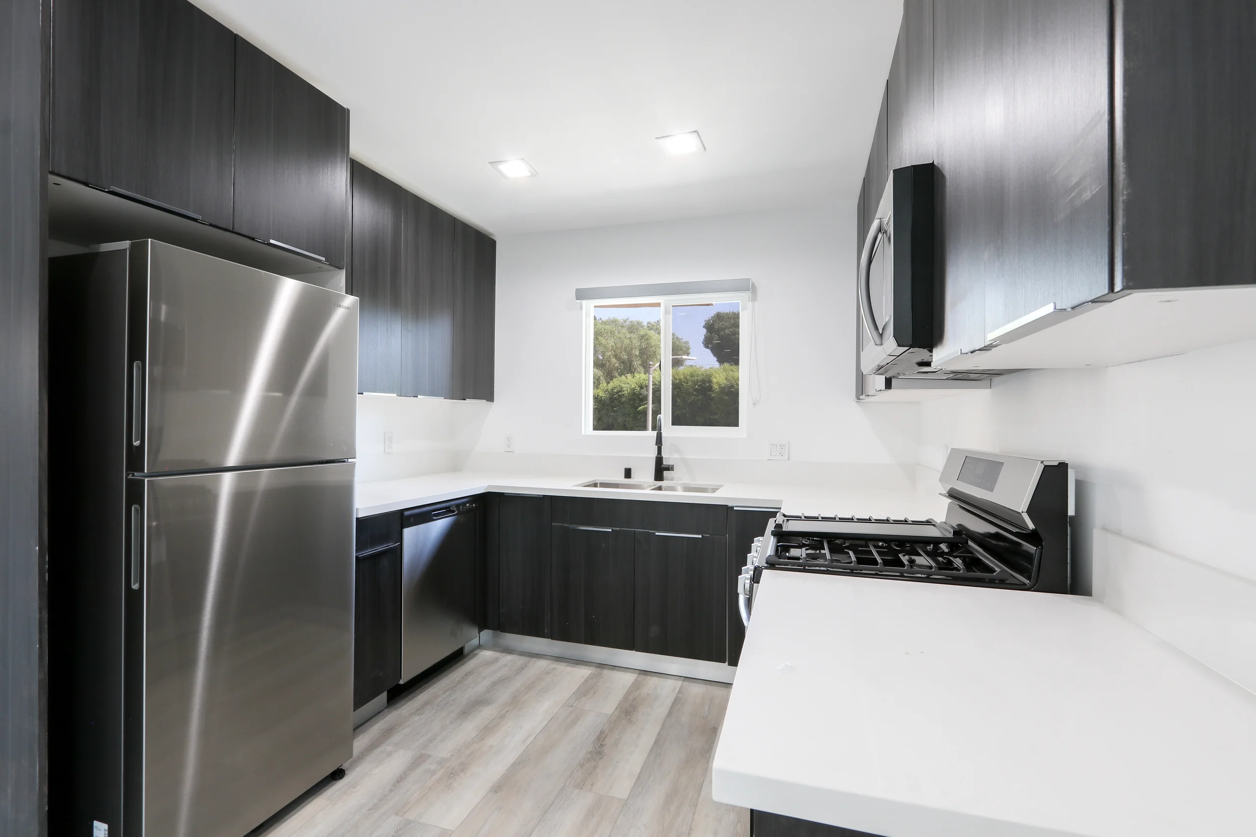 Modern kitchen with stainless steel appliances and granite countertops. (photo 2 of 21)