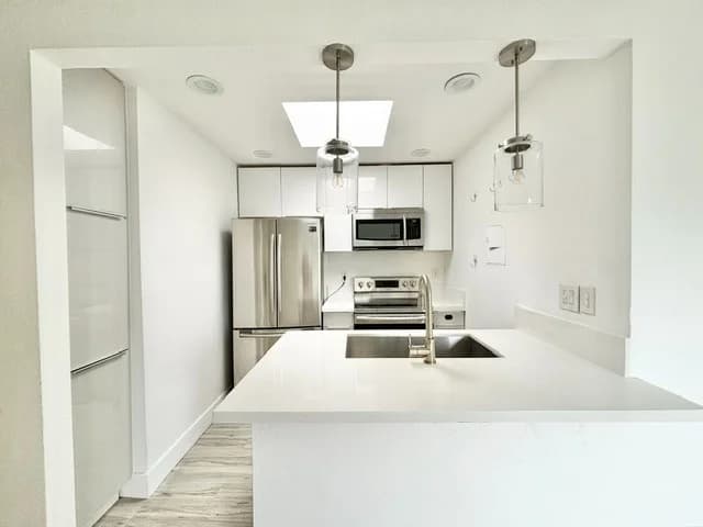 Modern kitchen with stainless steel appliances and quartz countertops. (photo 1 of 19)