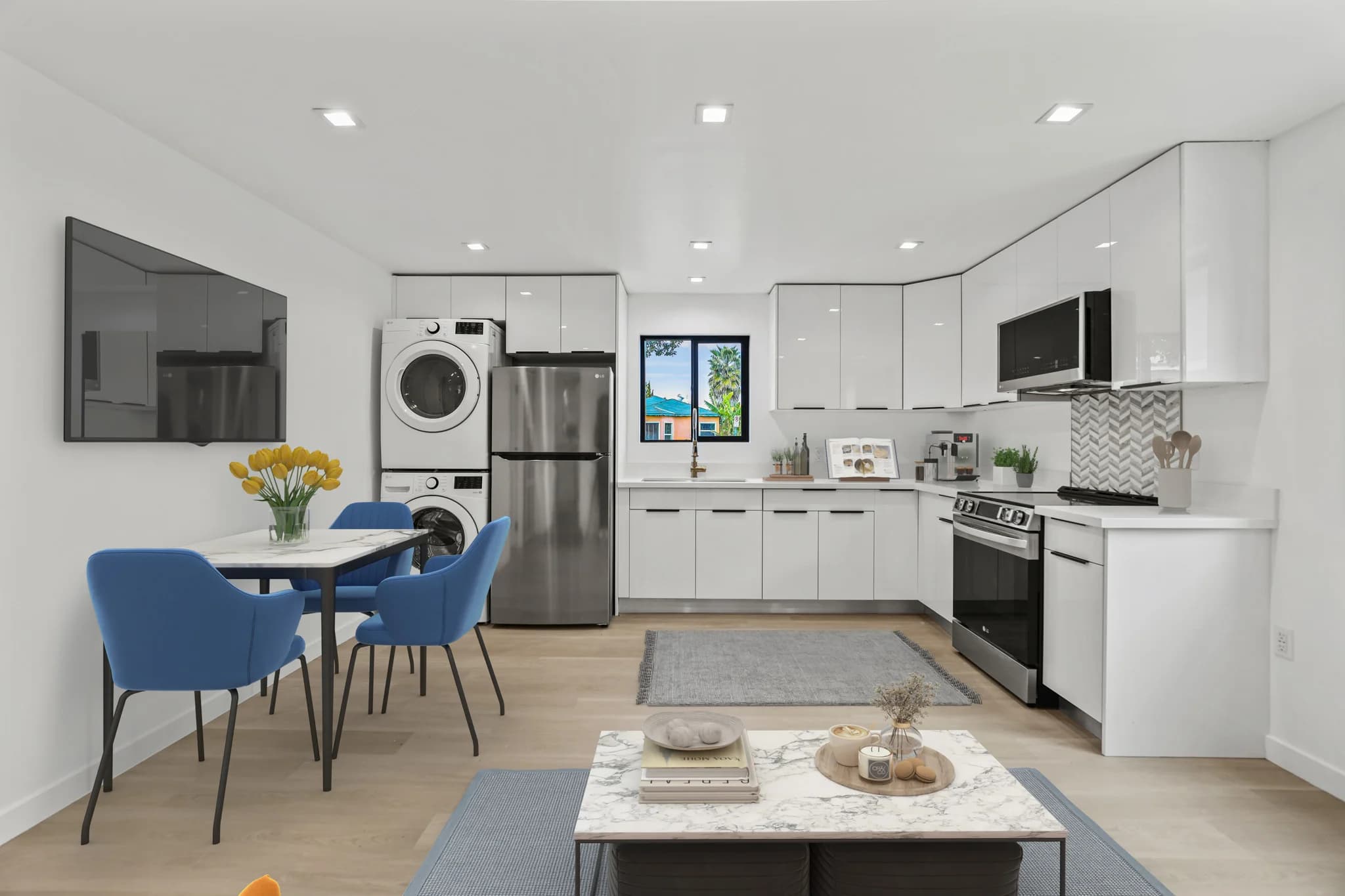 Modern kitchen featuring stainless steel appliances and a washer-dryer unit. (photo 1 of 24)