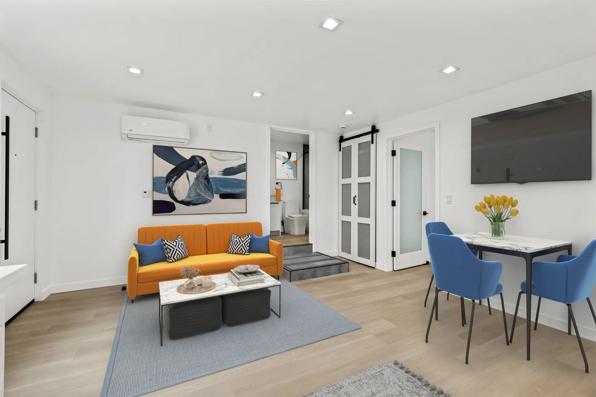Bright living room featuring hardwood floors and a modern design. (photo 2 of 24)