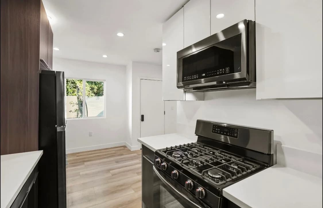 Modern kitchen featuring stainless steel appliances and sleek cabinetry. (photo 2 of 20)
