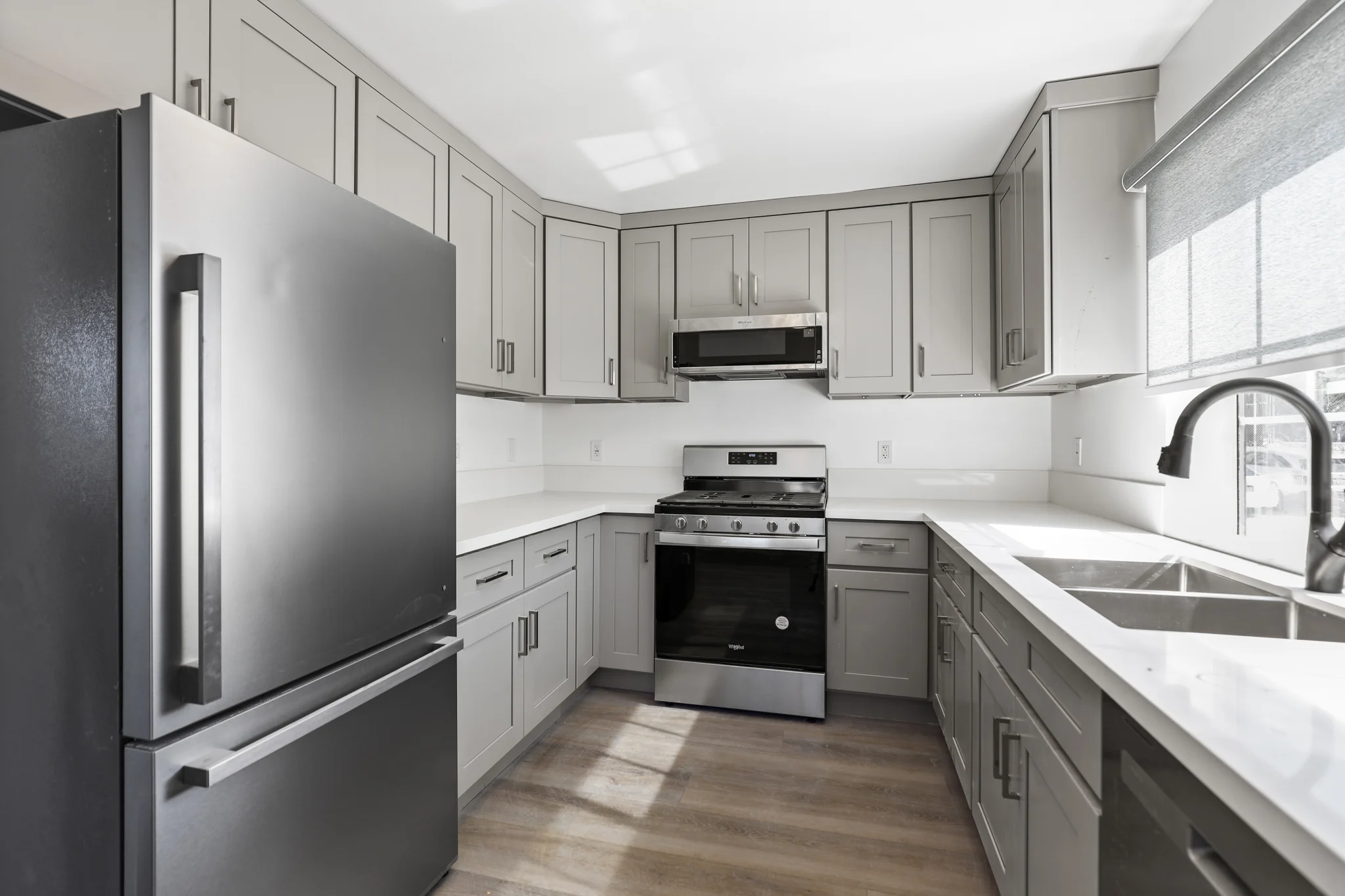 Modern kitchen with stainless steel appliances and granite countertops. (photo 2 of 17)
