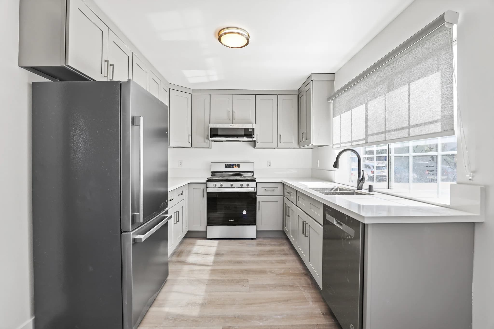 Modern kitchen with stainless steel appliances and quartz countertops. (photo 1 of 17)
