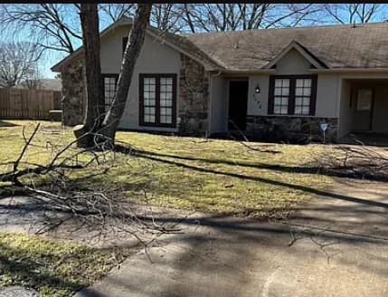 Charming exterior view with a stone facade and a driveway. (photo 2 of 8)