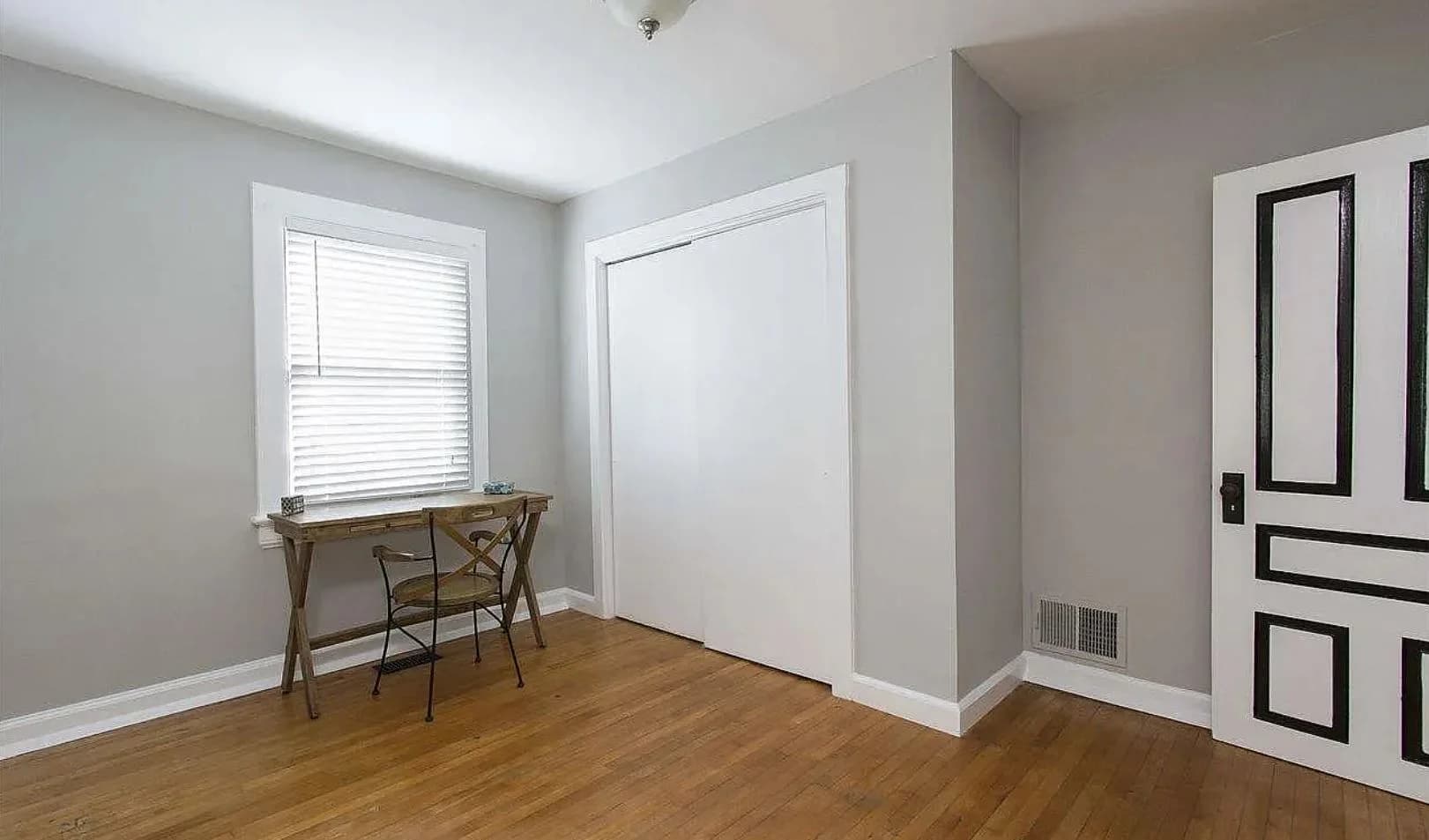 Small room with hardwood flooring and a desk. (photo 2 of 12)