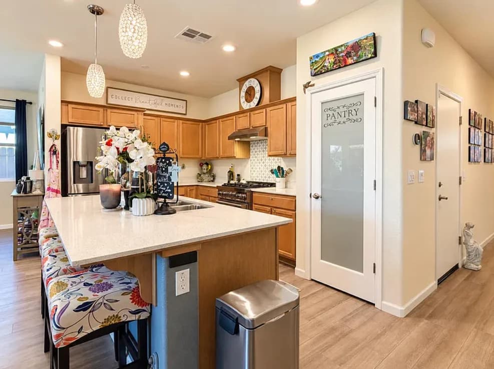 Modern kitchen with stainless appliances and an island. (photo 2 of 4)