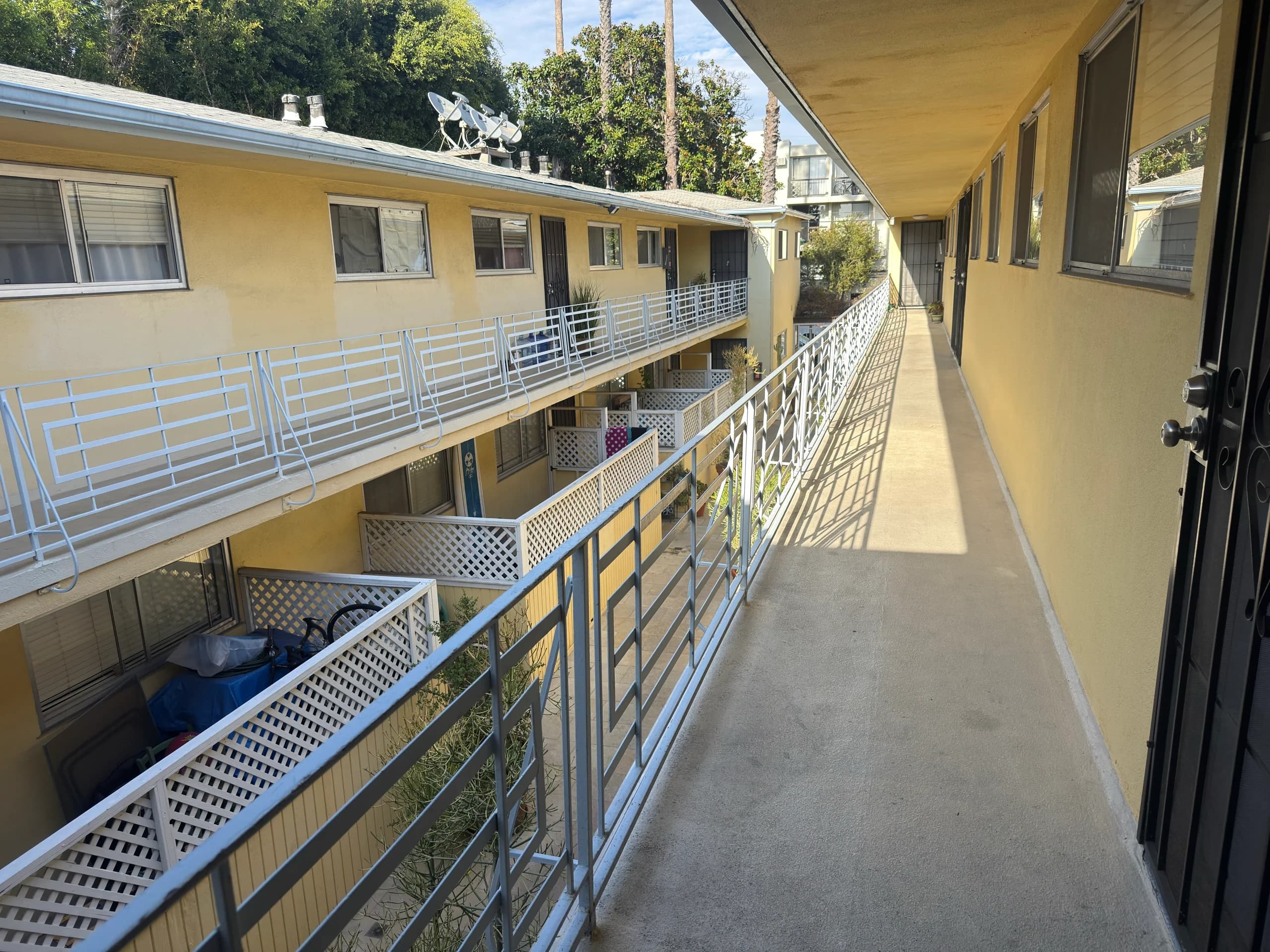 Shared walkway with balconies on either side. (photo 2 of 10)