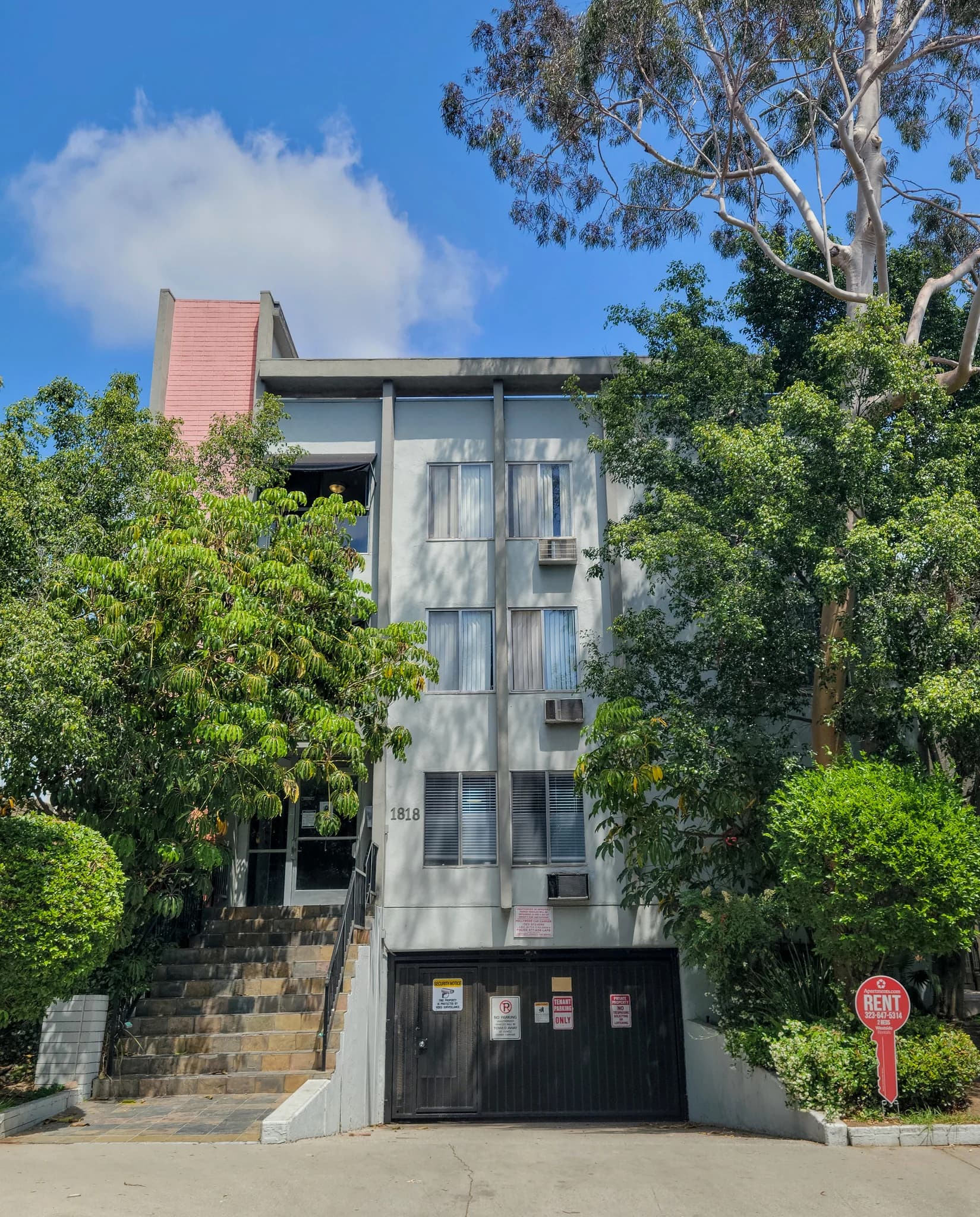 Well-maintained exterior of a multi-unit building with landscaping. (photo 1 of 16)