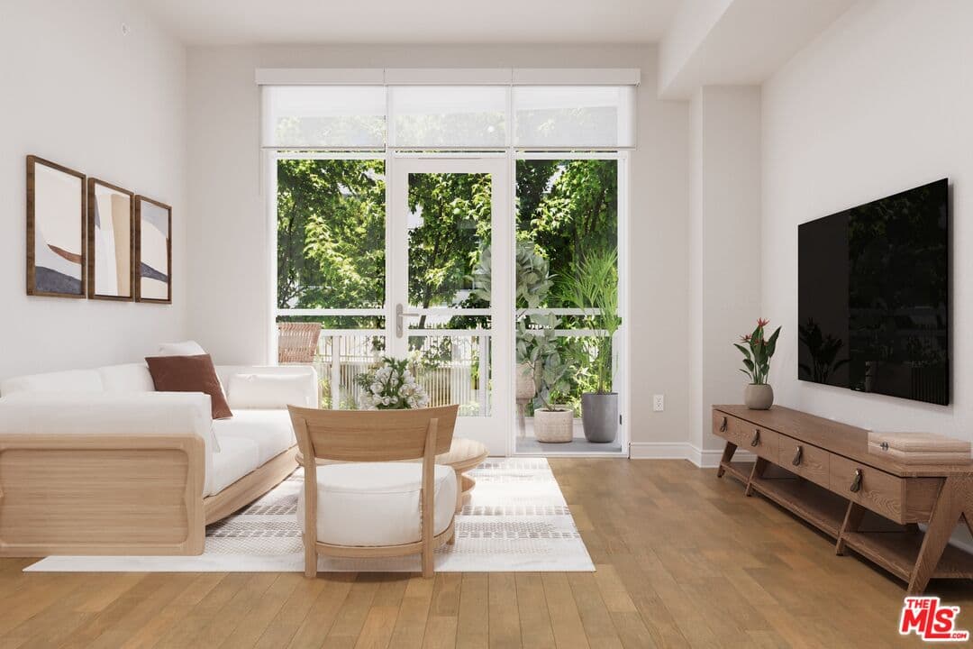 Bright living room with modern furnishings and balcony access (photo 1 of 25)