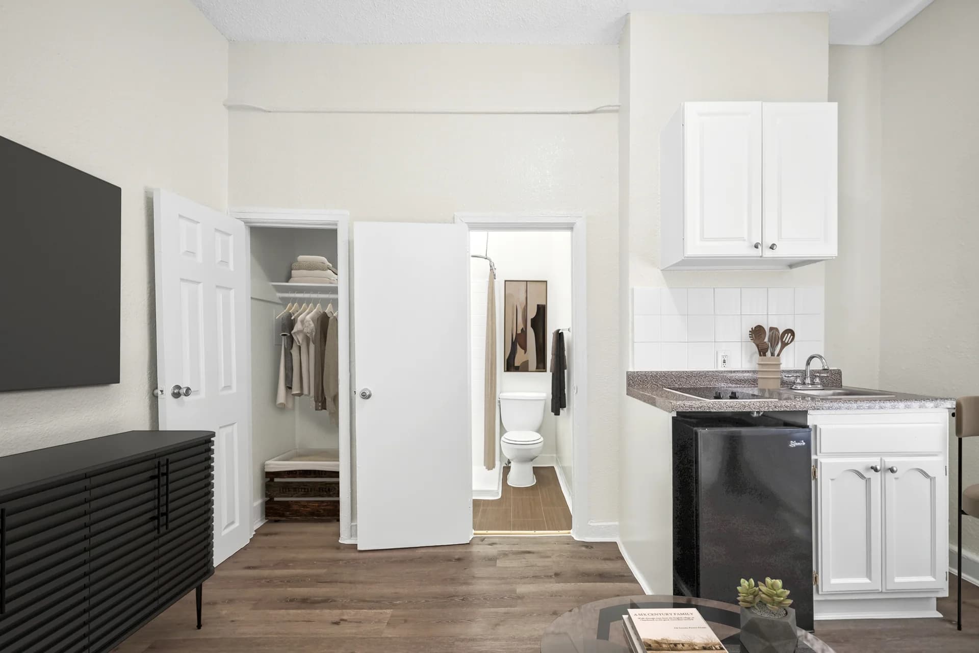 Compact kitchen area featuring granite countertops and stainless appliances. (photo 2 of 25)