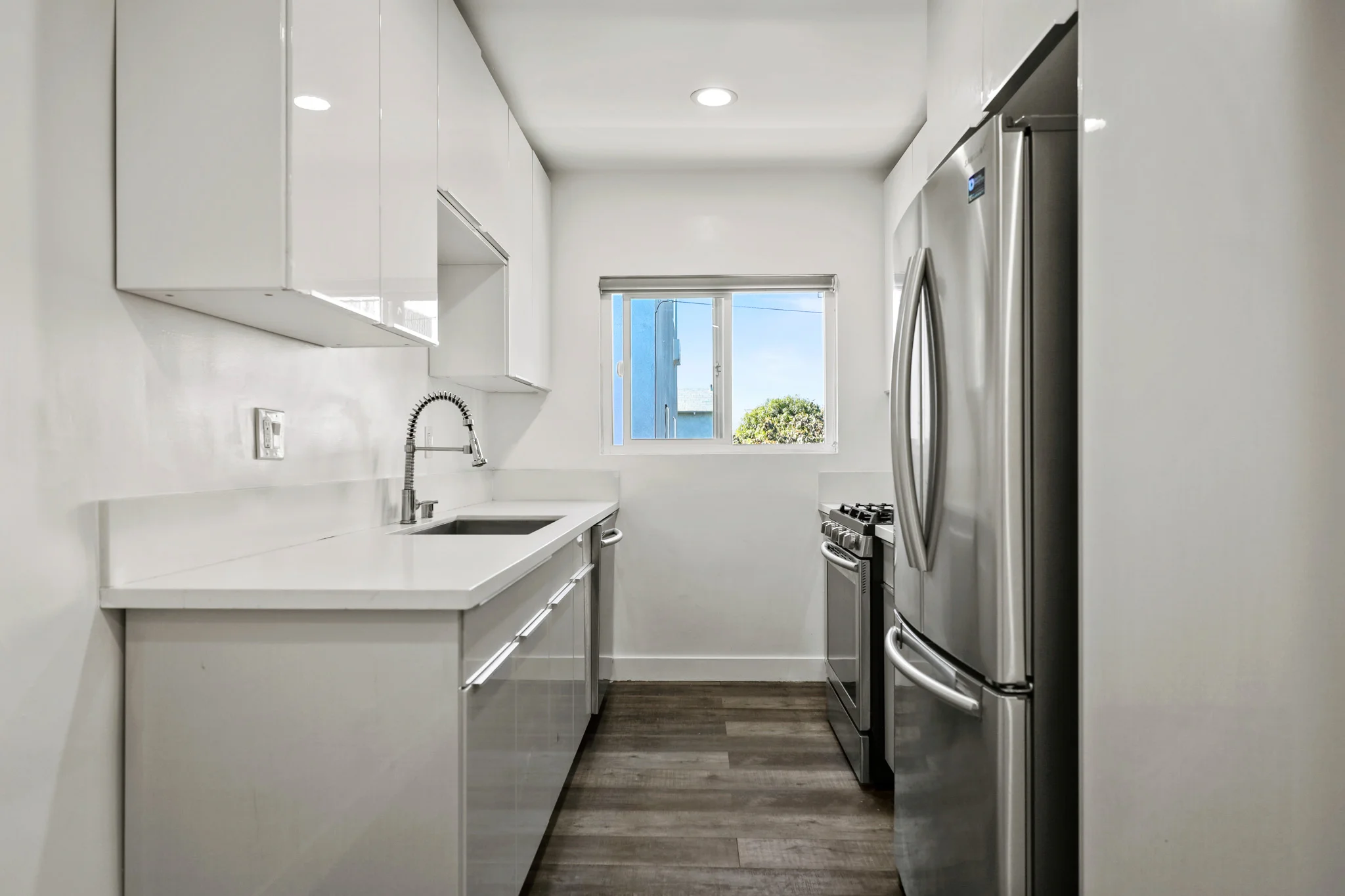 Modern kitchen featuring stainless steel appliances and granite countertops. (photo 2 of 17)