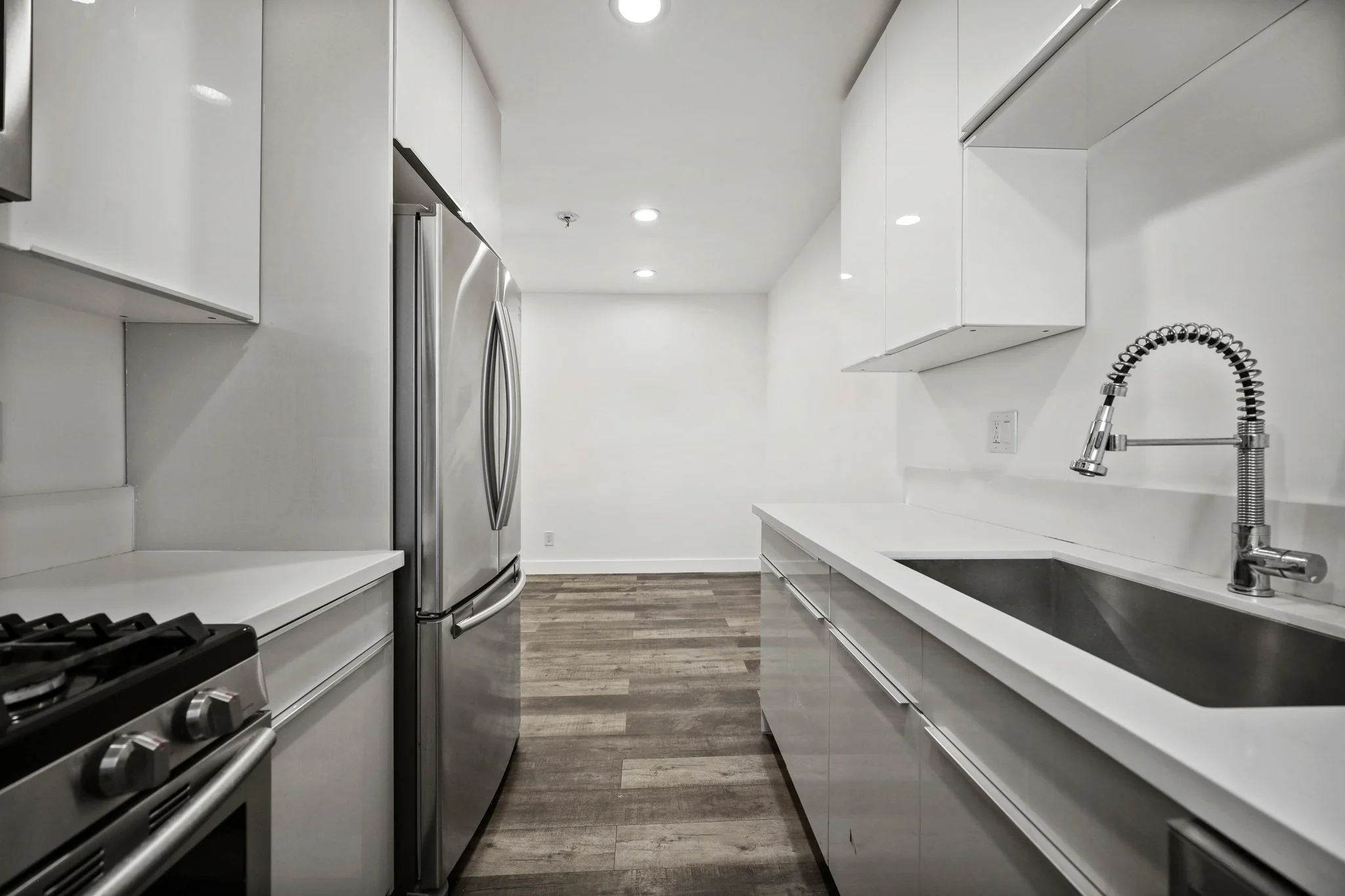 Modern kitchen featuring stainless steel appliances and sleek countertops. (photo 1 of 17)